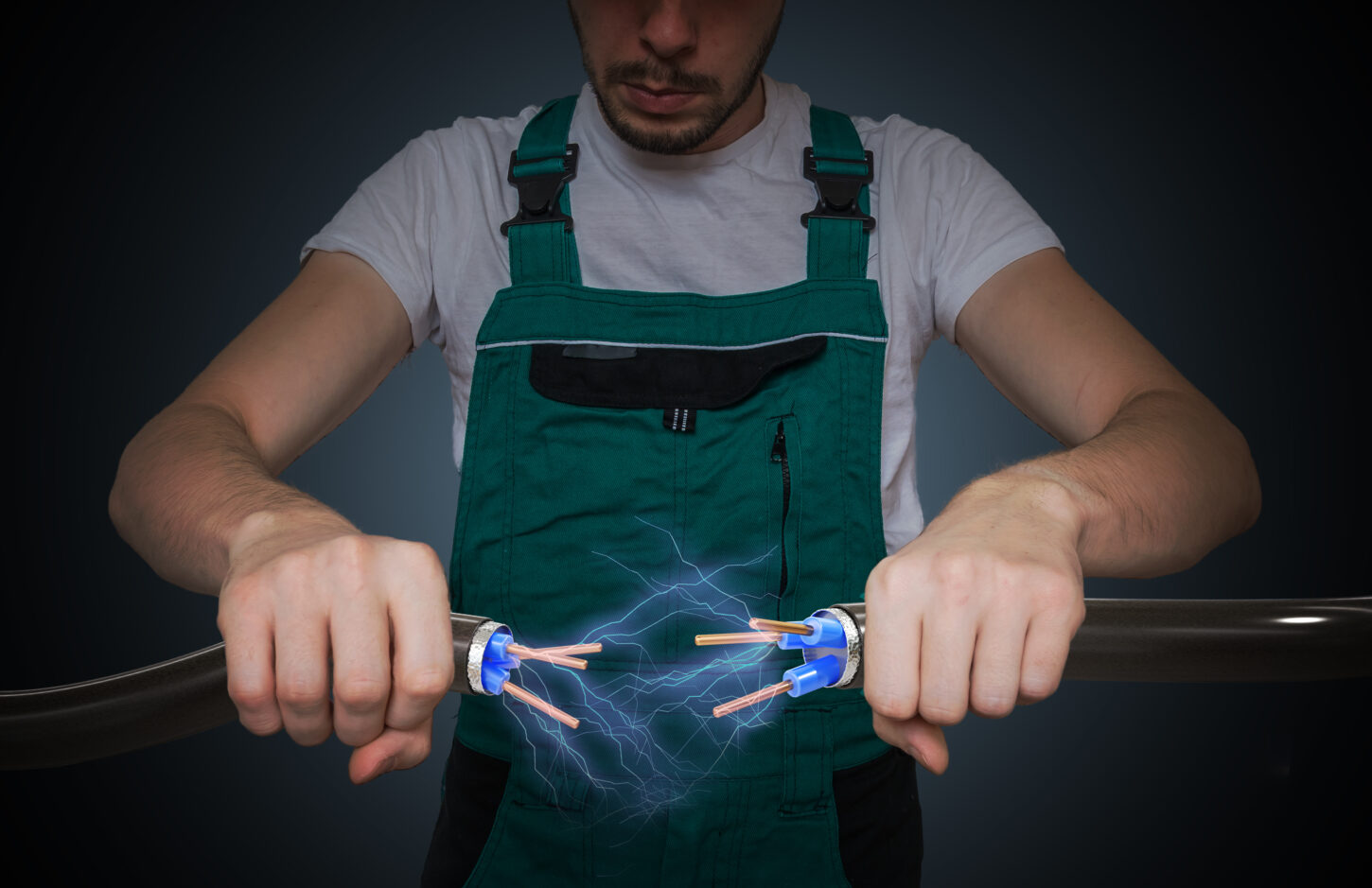 young-electrician-holds-cables-in-hands-and-connecting-them-lightning-and-electricity-around