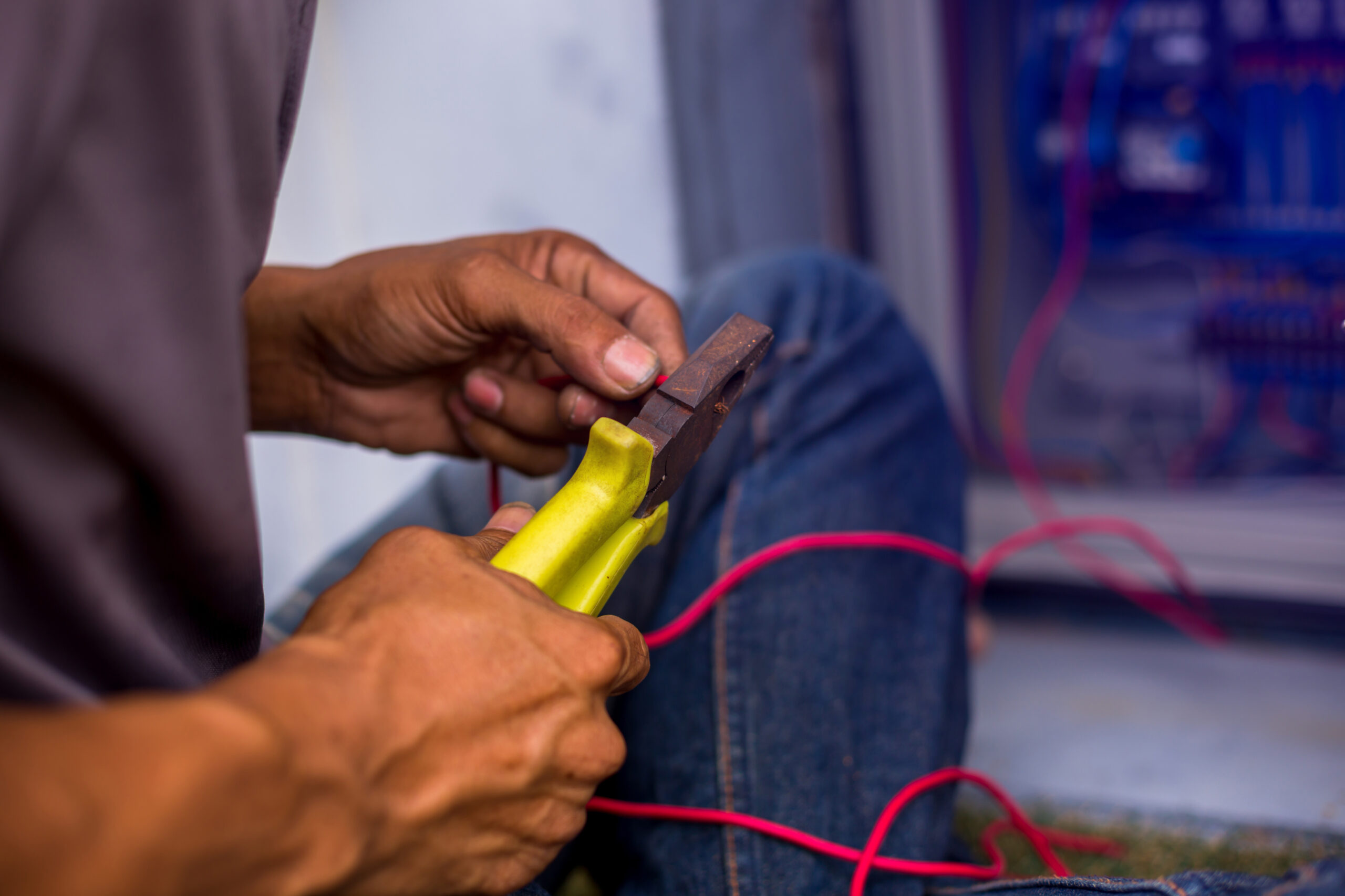 the-electrician-connected-the-electrical-wires-in-the-electrical-control-cabinet